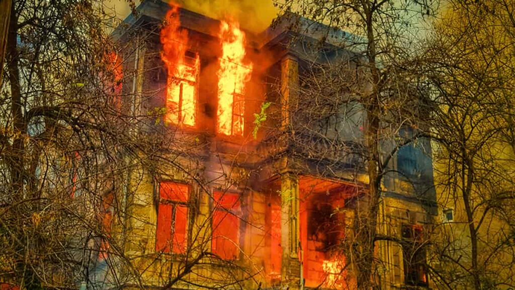 House engulfed in flames, showing how quickly a home can be destroyed without the protection of proper Homeowners Insurance.