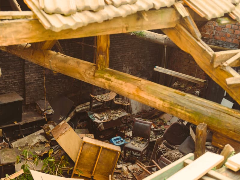 A destroyed home with its roof caved in, illustrating the kind of structural damage that Homeowners Insurance can help repair after natural disasters or sudden collapse.

