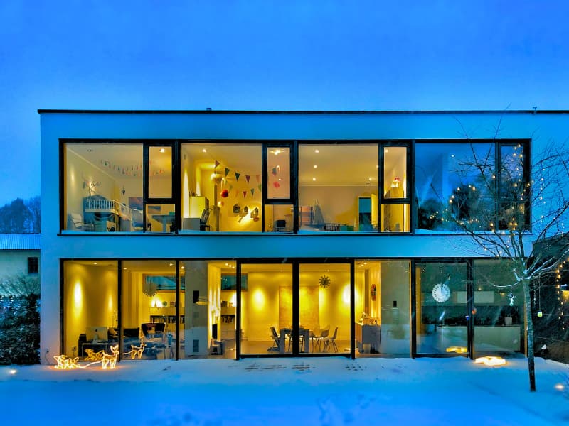 Modern smart home with energy-efficient windows and advanced lighting, potentially eligible for homeowners insurance discounts.