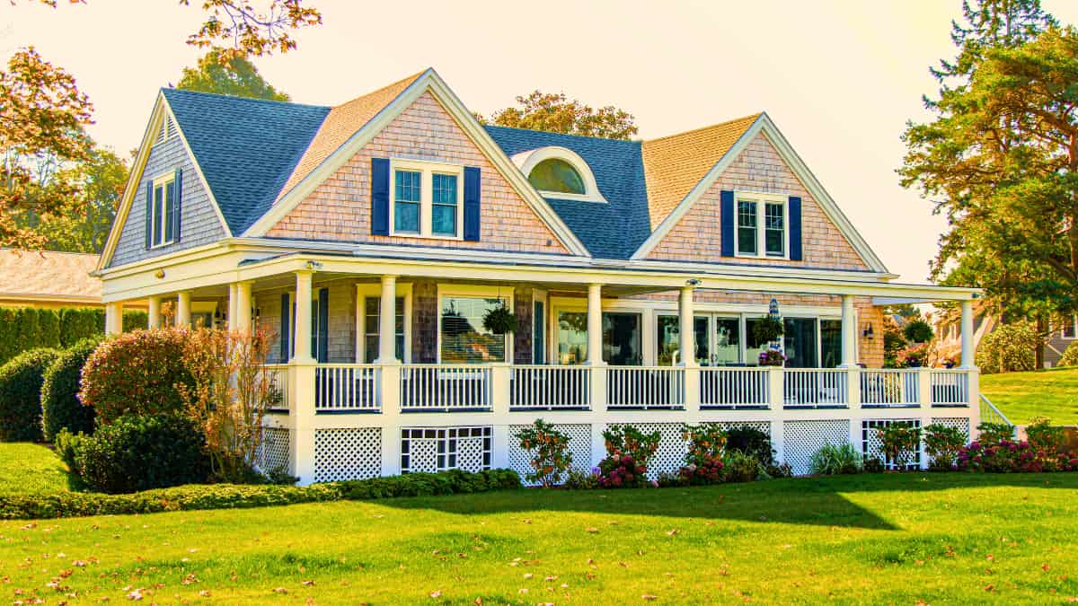 Charming Victorian-style home with classic wraparound porch, highlighting structural risks that often lead to discrepancies in your Homeowners Insurance Quote.